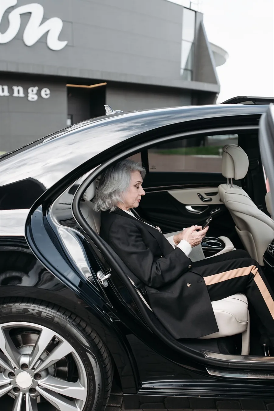 Afsahi chauffeur waiting in an airport arrivals hall to meet a client for a private transfer in Morocco